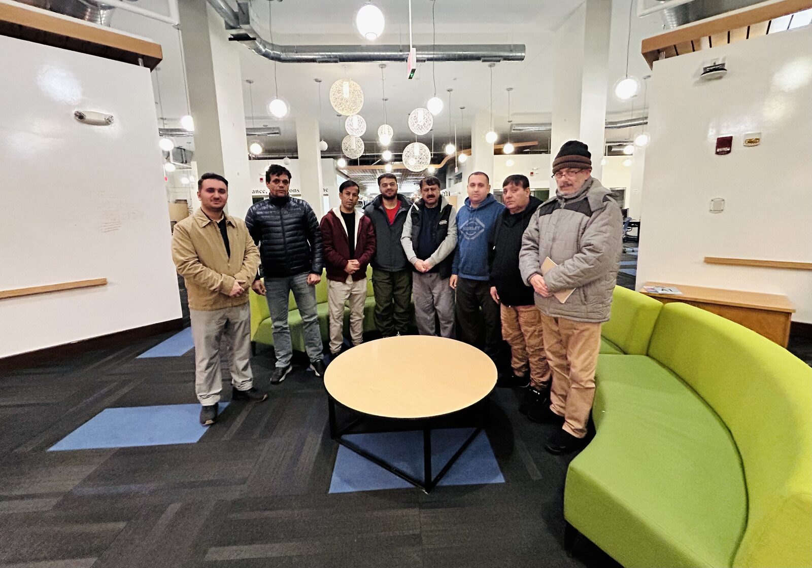 Sayed Matin Hussainy with participants in a community education program